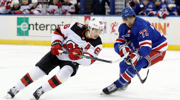 Dec 12, 2022; New York, New York, USA; New Jersey Devils center Jack Hughes (86) fights for the puck against New York Rangers center Filip Chytil (72) during the first period at Madison Square Garden.